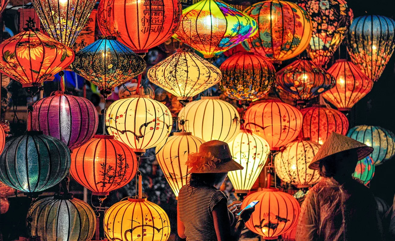 Two Person Standing Near Assorted-color Paper Lanterns